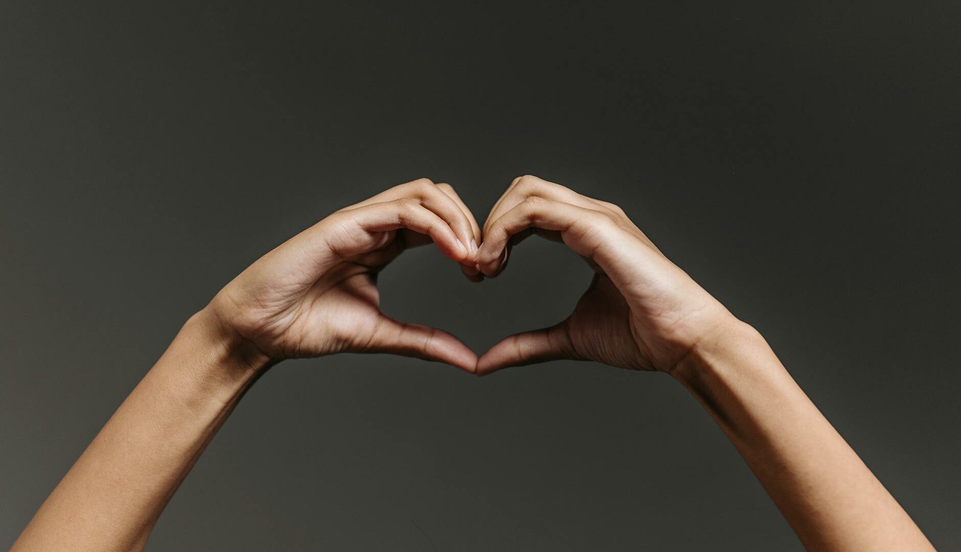 persons hand forming heart