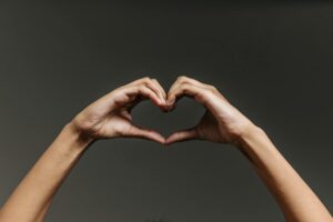 persons hand forming heart